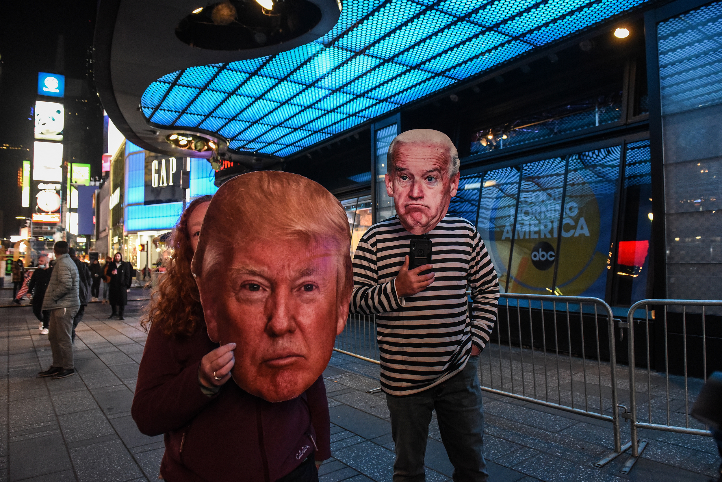 Two people, one with a Trump mask and one with a Biden mask, go to Times Square to await election results in New York City, U.S. November 3, 2020. (Stephanie Keith for The New York Times) NYTEX20